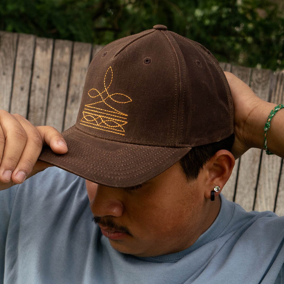 Young man wearing wrangler western cap in brown